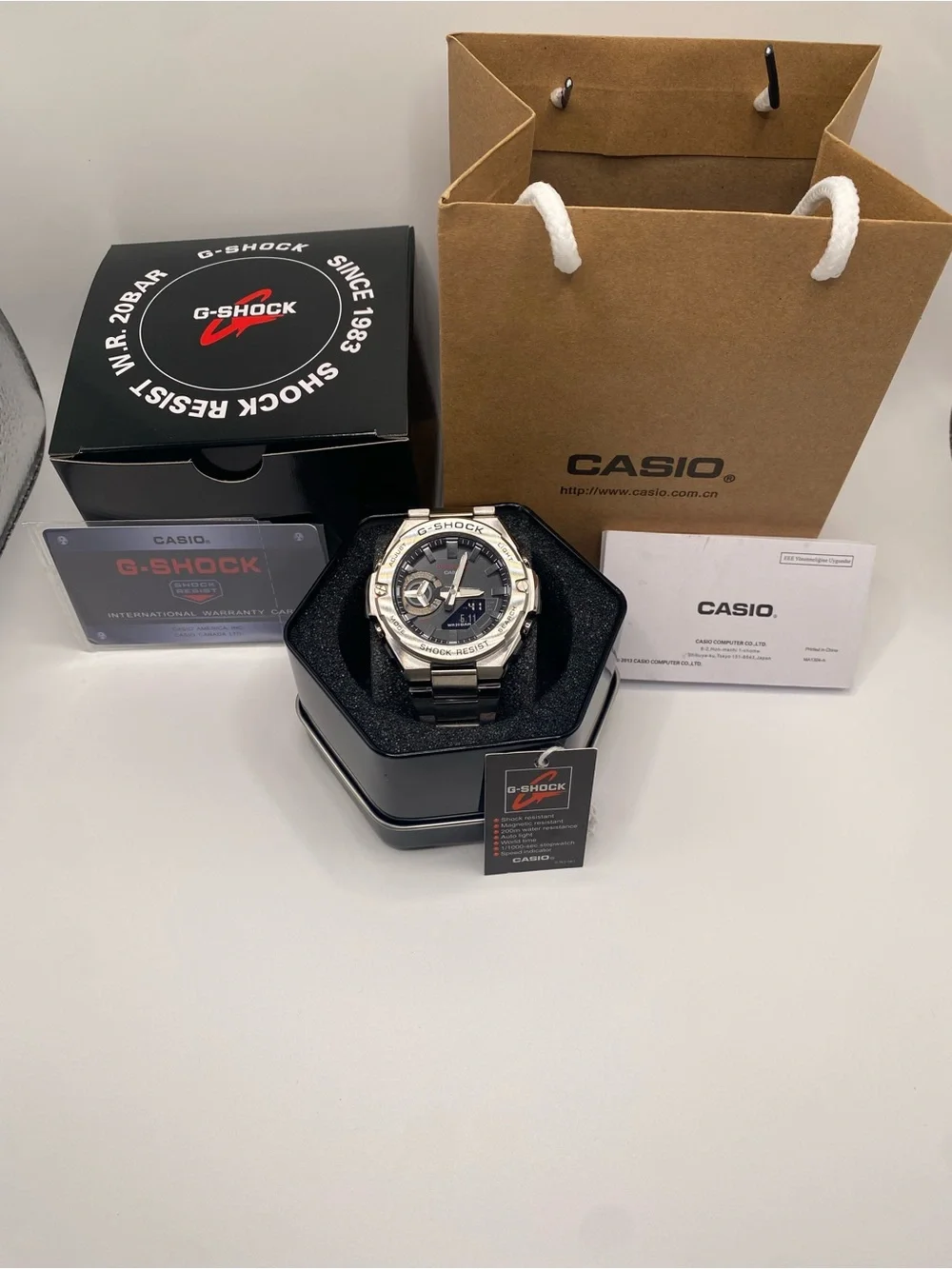 Casio G-Shock Men's Silver Watch with Black Dial and Metal Bracelet